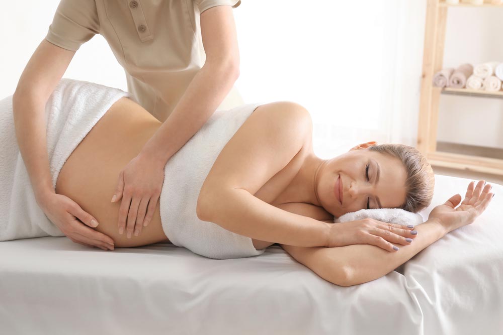 Pregnant Woman Having A Chiropractic Session