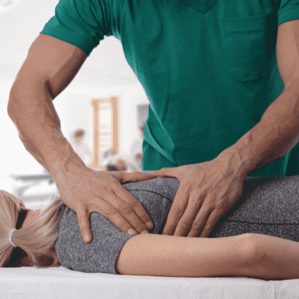 Chiropractor performing a spinal adjustment on a patient