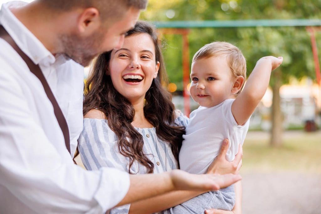 Happy family with toddler enjoying healthy lifestyle together